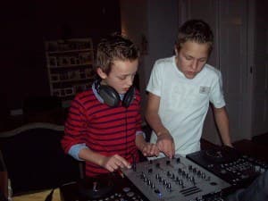 A young Ivo Adelaar and a friend behind a mixer at a drive-in show, headphones round his neck